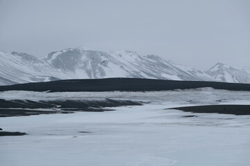 Magic moon ice desert landscape in volcanic panoramic nature scenery with black rocks on white snow...