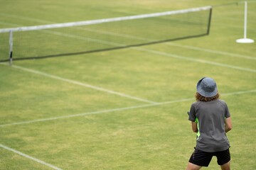 Amateur playing tennis at a tournament and match on grass in Melbourne, Australia 