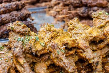 Selective focused a pile of chicken roasts on a street food market