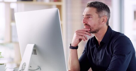 Hmm, I wonder what I should do here? Handsome mature confident focused caucasian business man sitting alone in his office with his hand on his chin thinking about work ideas while using his computer - Powered by Adobe