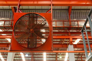 Big industrial cooler red fans in factory for reduced heat in operation ventilation of plant,...