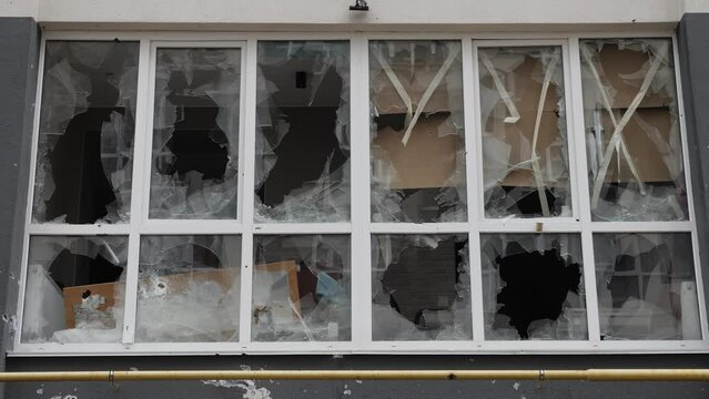 Aftermath shooting Ukraine shell civilian hitting building explosion glass. Shatter glass damage Ukraine war destruction building damage. Crash glass broken window house destroy building window crack