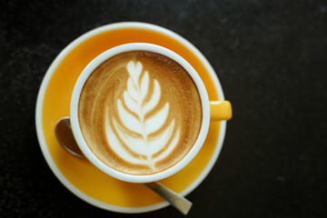 Coffee Latte leaf pattern face on black table