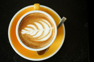 Coffee Latte leaf pattern face on black table