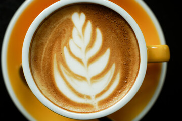 Coffee Latte leaf pattern face on black table