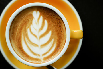 Coffee Latte leaf pattern face on black table