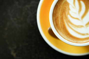 Coffee Latte leaf pattern face on black table