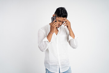 sad young man wearing white shirt making a call with copyspace on isolated background