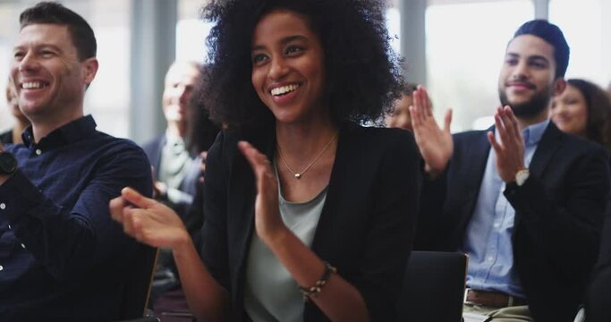 Earn the respect of your colleagues. Group of young diverse confident happy businesspeople clapping, applauding company success, achievement, attending a training workshop seminar in conference room