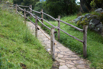 Fototapeta na wymiar Stone walkway with wooden railings