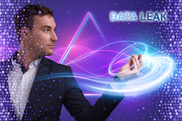 Obraz premium Business, Technology, Internet and network concept. Young businessman working on a virtual screen of the future and sees the inscription: Data leak