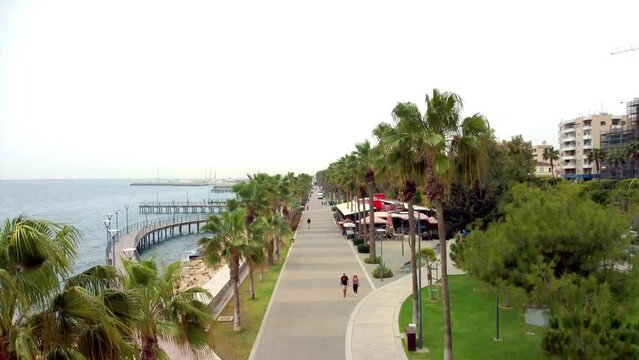 Drone flight over the Molos promenade in Cyprus in Limassol in the morning in windy weather in spring.
