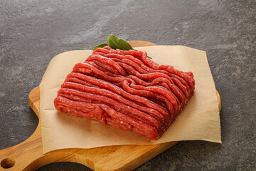 Raw beef minced meat over board