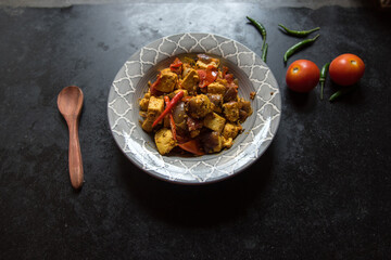 Top view of Kadai paneer in a bowl, a popular north Indian semi dry dish made by cooking paneer or...