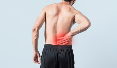 Man with back problems, shirtless man with back problems on isolated background, lumbar problems concept, rear view of sore man with back pain