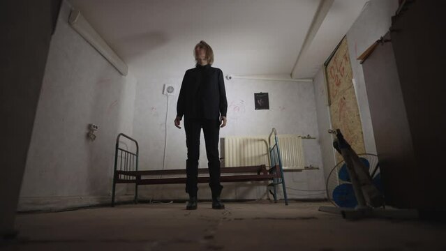 A woman in an abandoned mystical room. The poltergeist moves objects, the bed flew off to the wall.