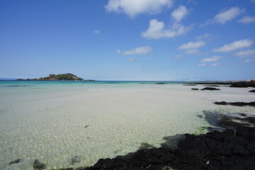 fascinating seascape with shoaling beach and rocks and island