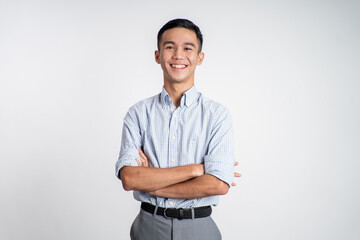 asian young man smiling with hands crossed on isolated background