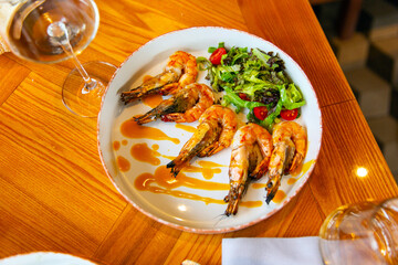 Appetizing fried shrimp in mustard sauce with fresh vegetables