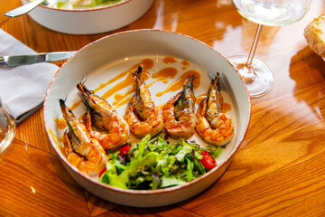 Appetizing fried shrimp in mustard sauce with fresh vegetables