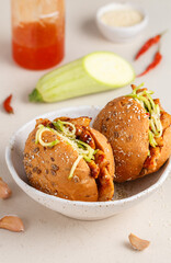 Delicatessen sandwiches made of whole-grain buns with fried turkey or chicken, zucchini salad and hot sauce with sesame and sunflower seeds. Healthy fast food. Selective focus