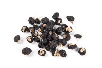 Black wolfberry or black goji berries isolated on white background