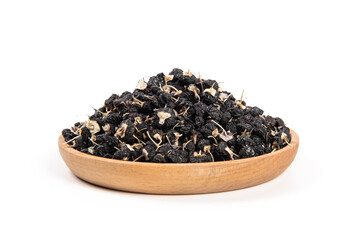 Black wolfberry in wood plate isolated on white background