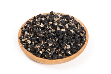 Black wolfberry in wood plate isolated on white background