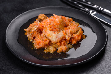 A delicious dish of hake fish in chunks in tomato sauce with spices and herbs