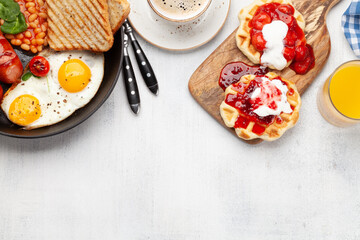 English breakfast with fried eggs, beans, bacon and sausages