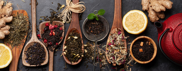 Various dried tea in wooden spoons