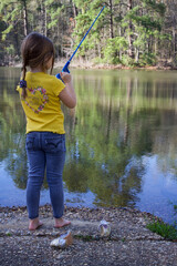 girl fishing by the pond