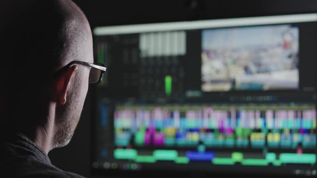 Experienced video editor working on a big project. A man edits a blog or a movie. Freelance