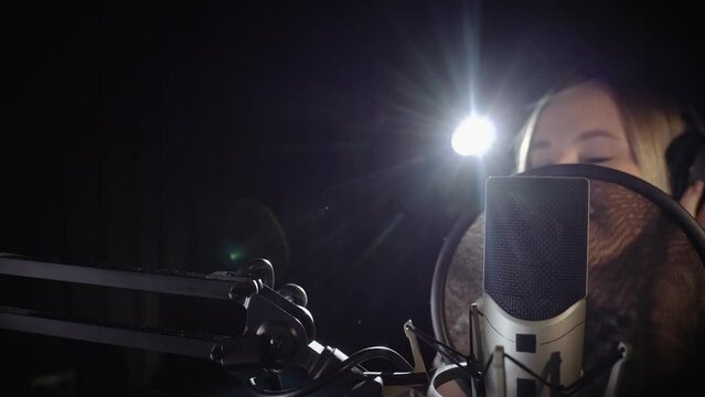 young singer recording new song in studio