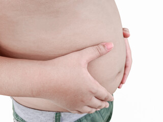 The boy stood holding a fat belly with excess weight. weight in diet concept