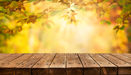Naklejka na ściany i meble Empty old wooden table with autumn background