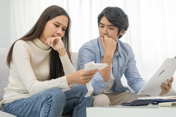 Stressed financial owe asian young couple love sitting suffer, stressed and confused by calculate...