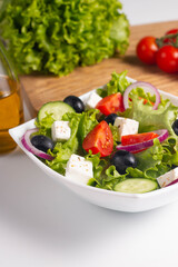 Greek salad with fresh tomatoes, cucumber, olives, feta cheese and red onion. Healthy and diet food concept.