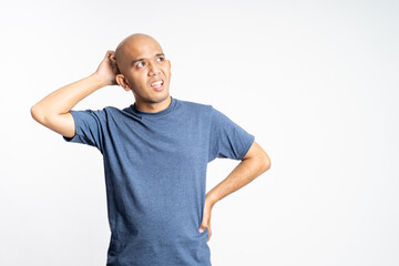 confused asian bald man holding his bald head on isolated background