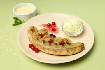 Concept of tasty dessert, grilled banana on green background