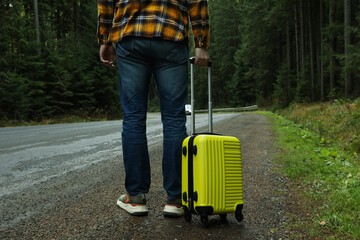 Adventure and tourism concept, young man traveling by auto stop