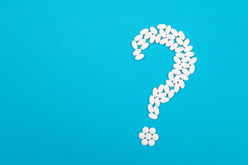 Question Mark Made from White Pills and Tablets, Lying on Blue Background. Global Pharmaceutical Industry and Medicinal Products