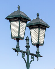 Fototapeta na wymiar Lantern on a metal pole in the city during