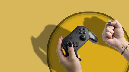 Video game console controller in gamer hand isolated on yellow background. © Prathankarnpap