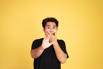 asian young man with scared gesture on isolated background