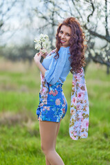 portrait of a beautiful brunette woman in spring nature.