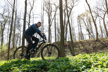 Young man rides a mountain bike