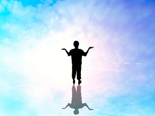 Fototapeta na wymiar 両手を上に向けて立つ男性全身シルエット_スピリチュアルな空背景