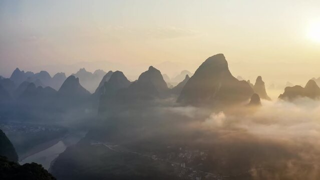 Aerial footage of beautiful mountain and river natural landscape in Guilin at sunrise, China. Lijiang River Scenic Area is a famous tourist attraction in Guilin.