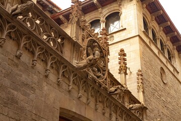 Facade of Carrer del Bisbe in the Gothic Quarter of Barcelona, Catalonia, Spain, with its antique gorgolas.